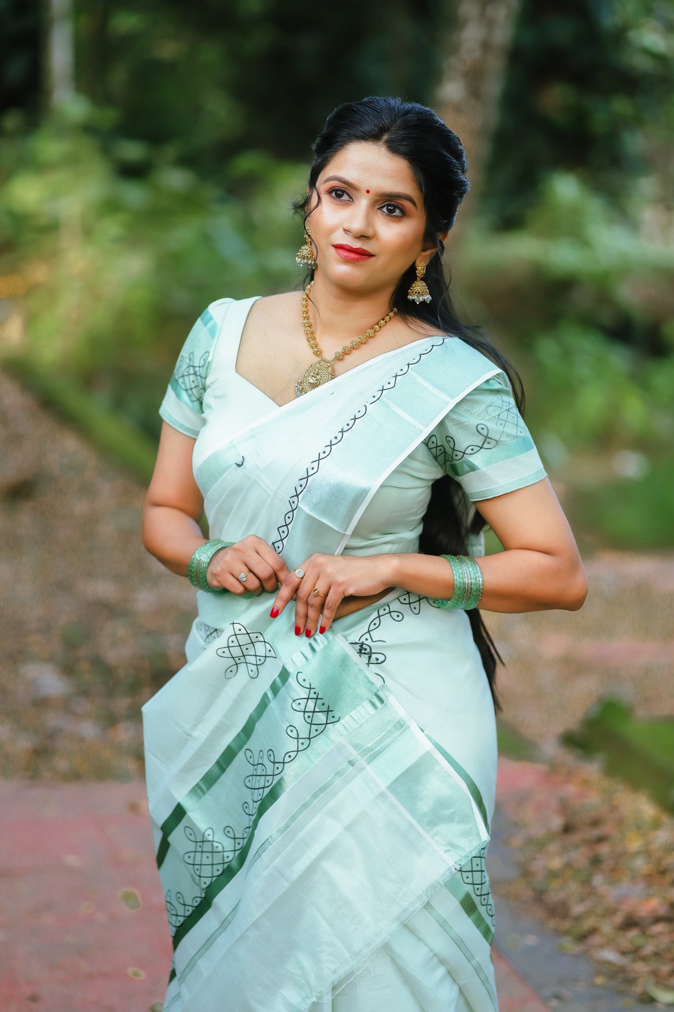 Green tissue Kerala Set Mundu with Kolam prints and matching printed blouse (2.80m).