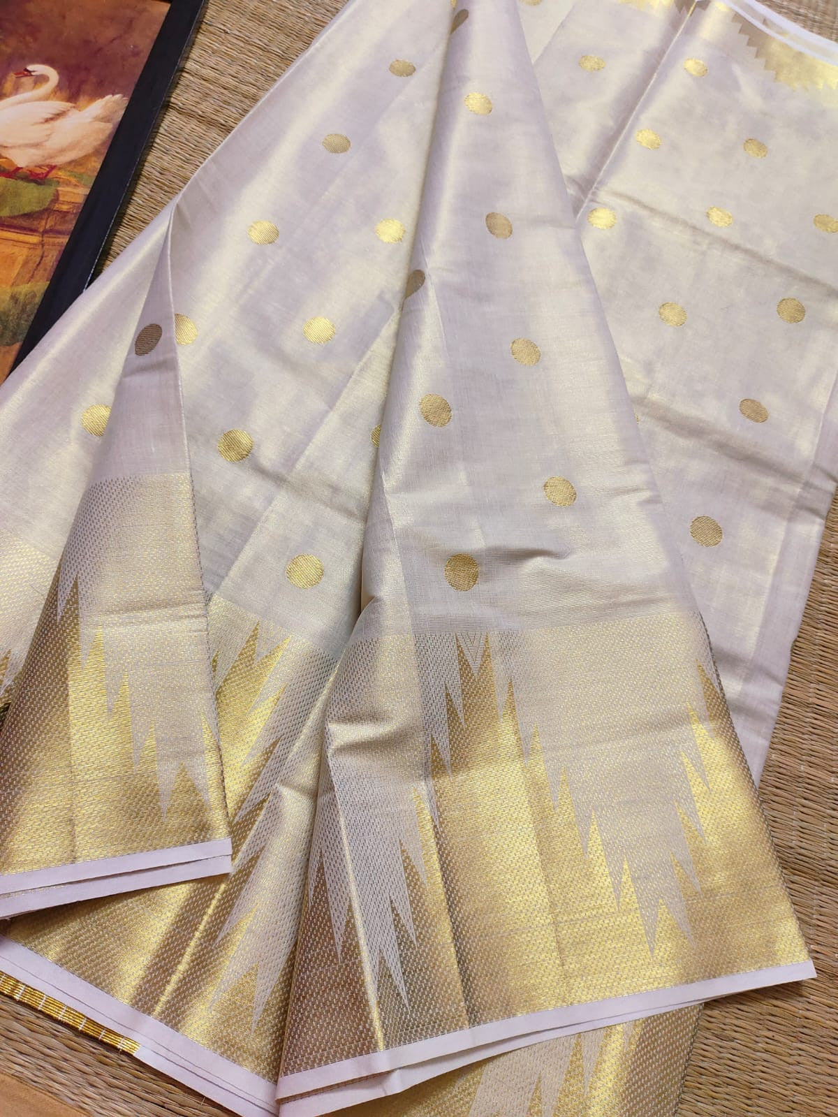 Premium Tissue Saree With Temple Border And All-Over Polka Dots.
