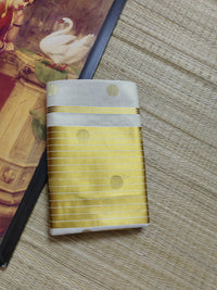 Premium Tissue Saree With Temple Border And All-Over Polka Dots.