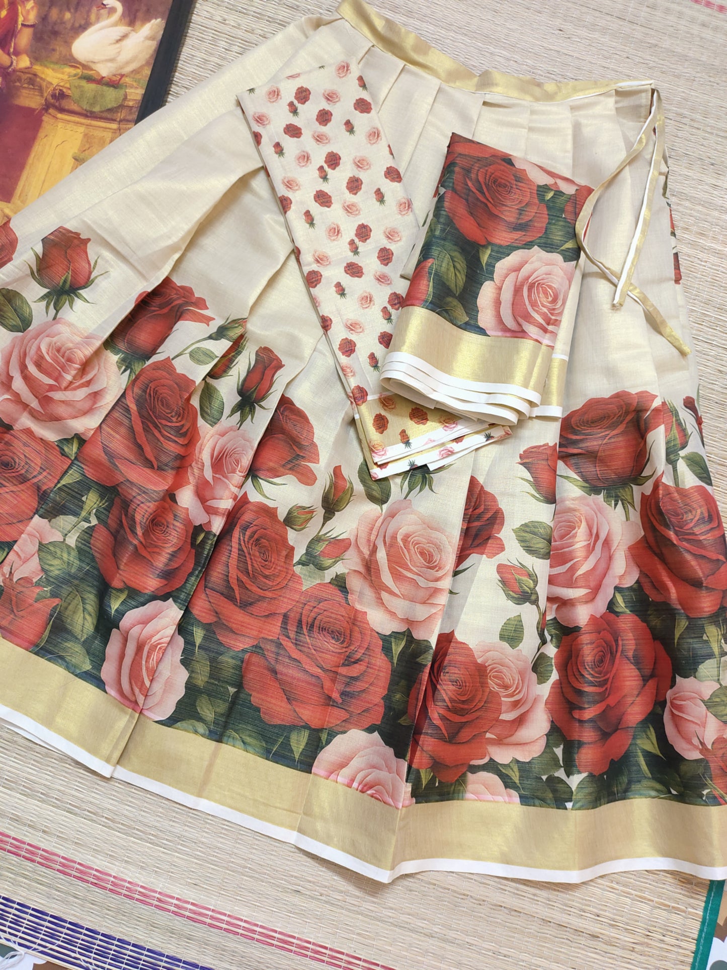 Tissue Dhavani set with red rose printed stitched skirt and matching unstitched blouse.