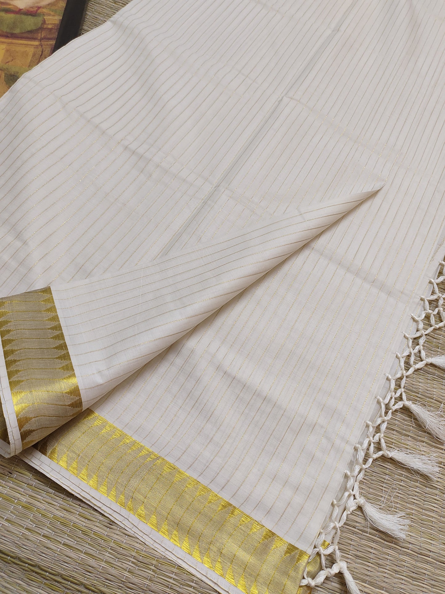 Premium cotton saree featuring all-over stripes and tassels