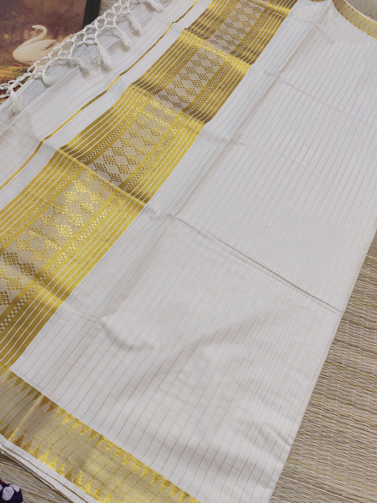 Premium cotton saree featuring all-over stripes and tassels