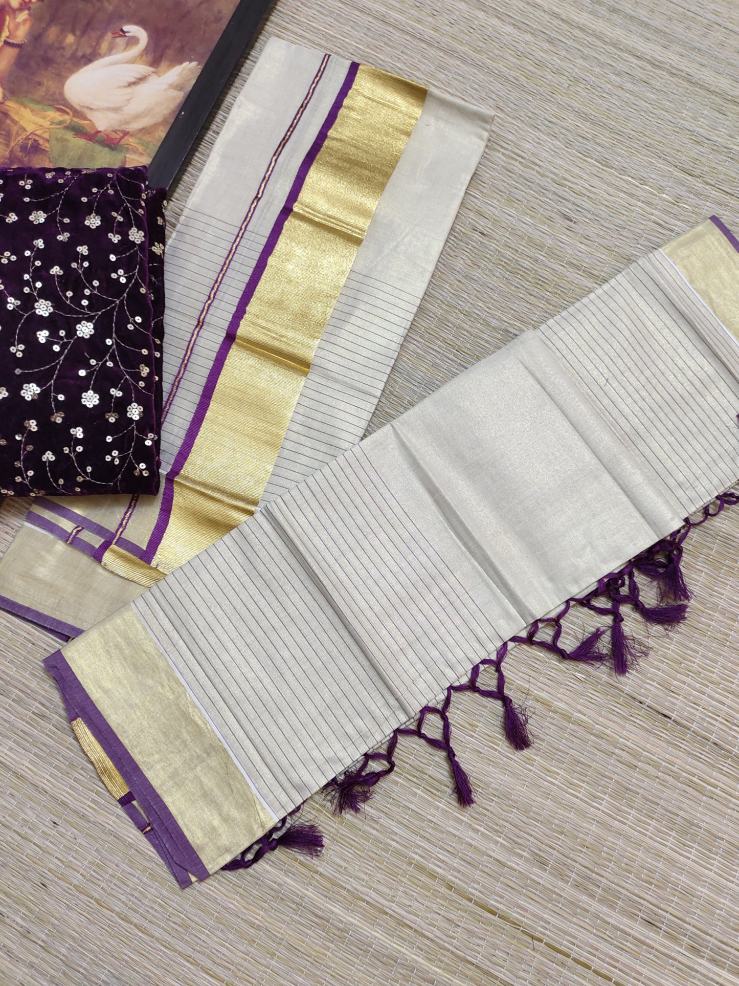 Half Plain Half Lines Tissue Set Mundu With Tassels And Velvet Sequence Blouse.