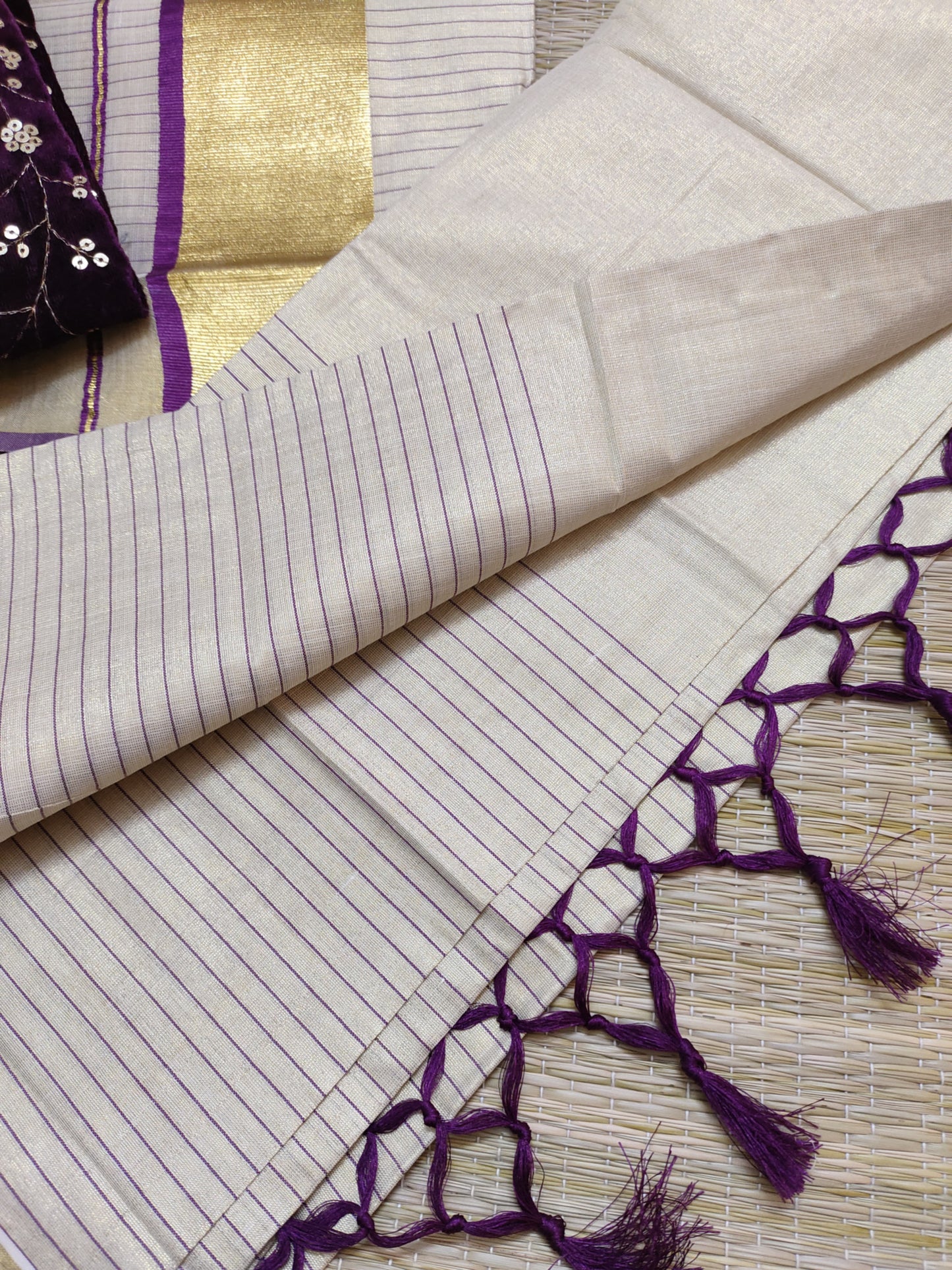 Half Plain Half Lines Tissue Set Mundu With Tassels And Velvet Sequence Blouse.