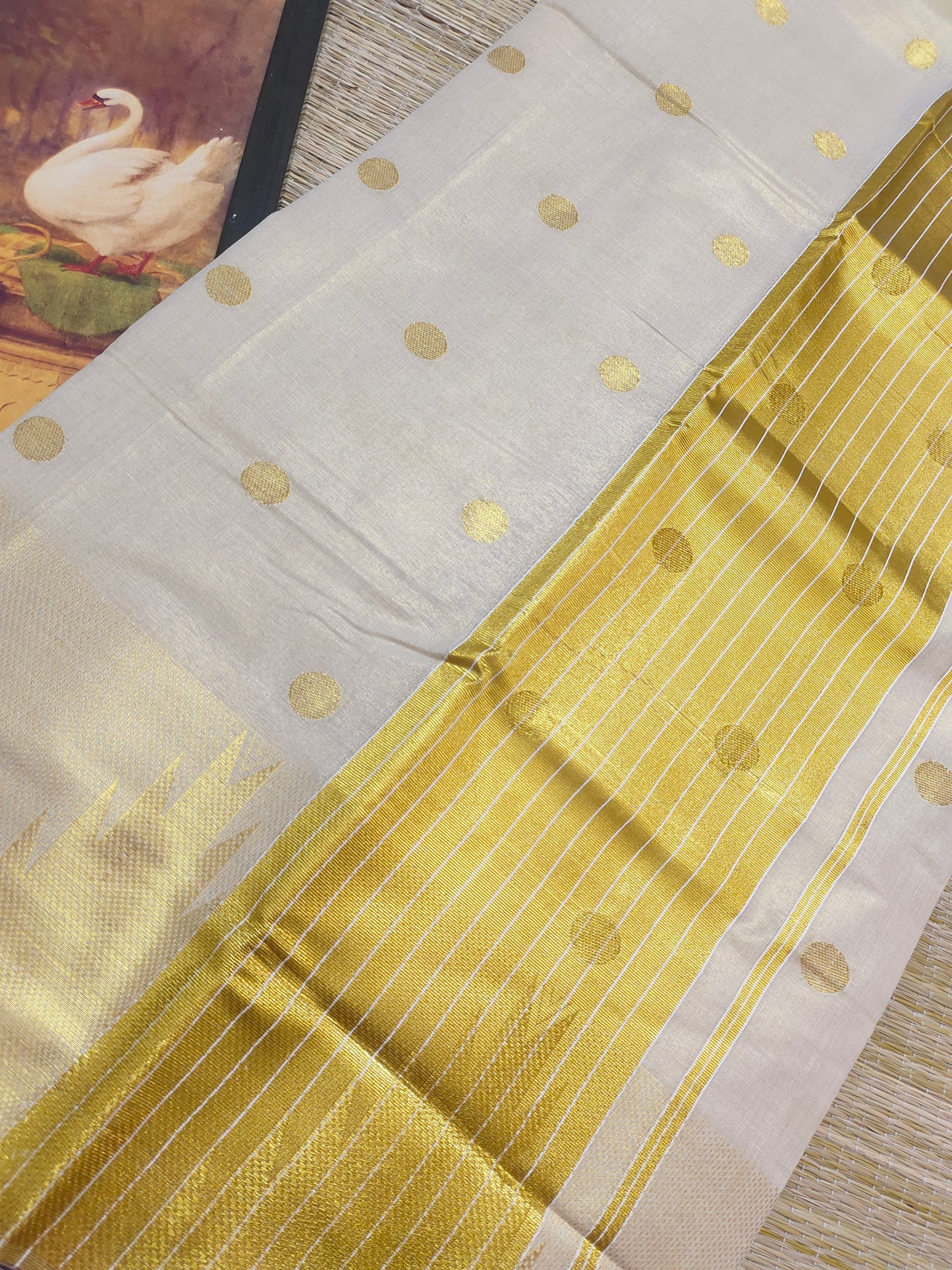 Premium Tissue Saree With Temple Border And All-Over Polka Dots.