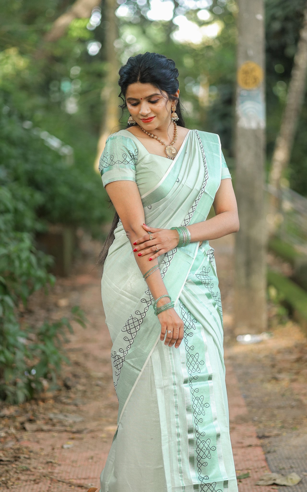 Green tissue Kerala Set Mundu with Kolam prints and matching printed blouse (2.80m).