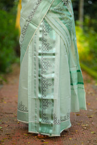 Green tissue Kerala Set Mundu with Kolam prints and matching printed blouse (2.80m).