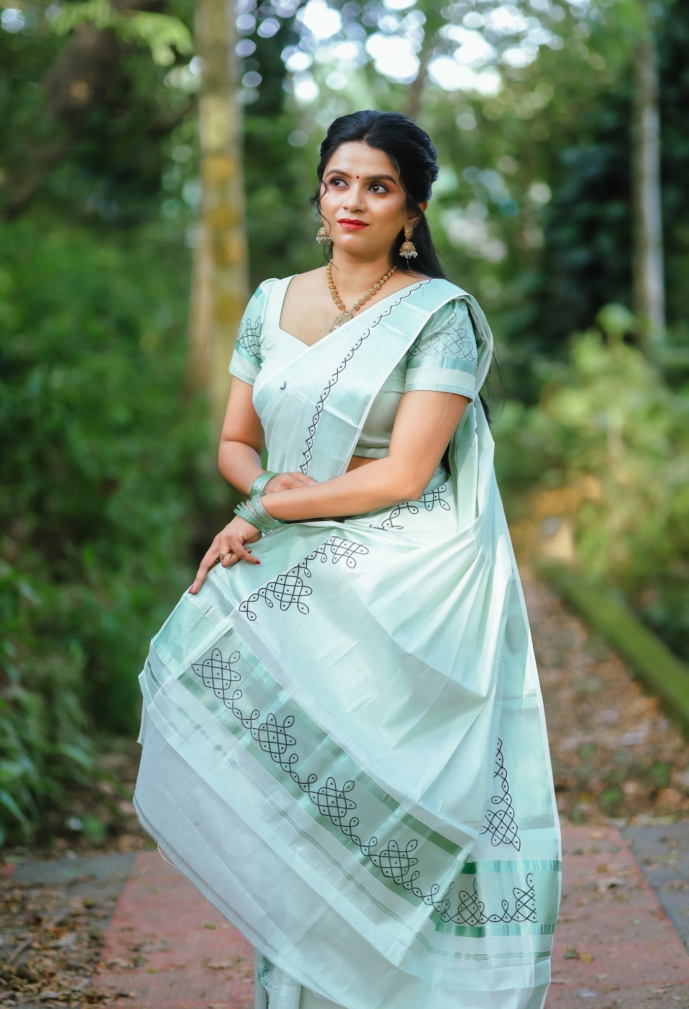 Green tissue Kerala Set Mundu with Kolam prints and matching printed blouse (2.80m).